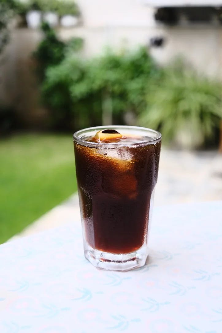 A glass with iced black coffee.