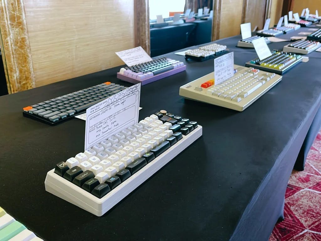 A table with rows of mechanical keyboards laid out